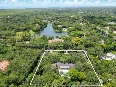 Set on a rare, oversized 56,192 SF lot in one of Coral Gables'
