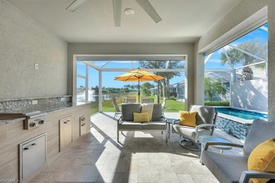 Welcome to this extraordinary lakefront home in vibrant Estero