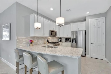 Welcome to this extraordinary lakefront home in vibrant Estero