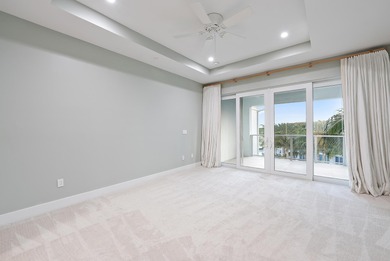 An elevated expression of coastal living, this three-story Water