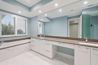 An elevated expression of coastal living, this three-story Water