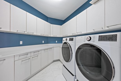 An elevated expression of coastal living, this three-story Water