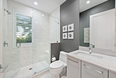 An elevated expression of coastal living, this three-story Water