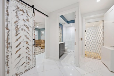 An elevated expression of coastal living, this three-story Water