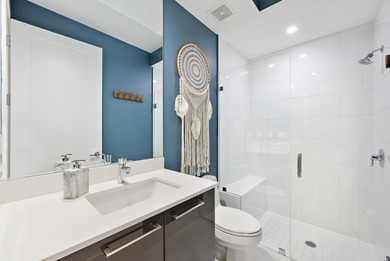 An elevated expression of coastal living, this three-story Water