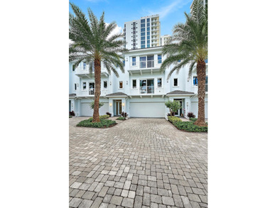 An elevated expression of coastal living, this three-story Water