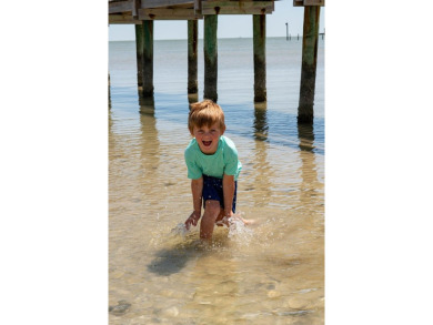 Tucked behind the gates of Sea Shell Shores, lies a home of