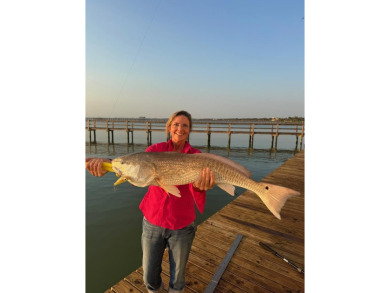 Tucked behind the gates of Sea Shell Shores, lies a home of