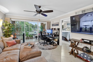 Welcome to waterfront living at sun-swept Unit 203 in