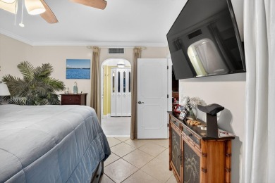 Welcome to waterfront living at sun-swept Unit 203 in