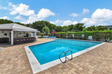 Welcome to waterfront living at sun-swept Unit 203 in