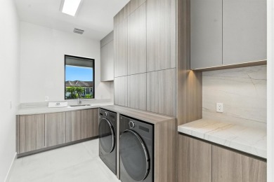 This extraordinary two-story waterfront estate is purpose-built