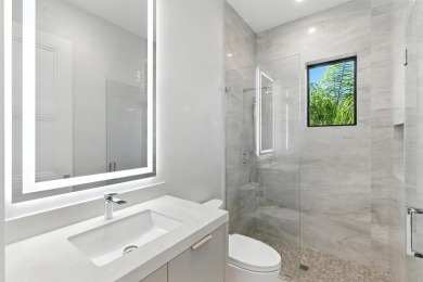 This extraordinary two-story waterfront estate is purpose-built