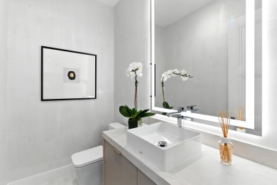 This extraordinary two-story waterfront estate is purpose-built