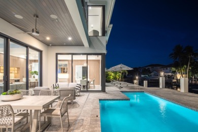 This extraordinary two-story waterfront estate is purpose-built