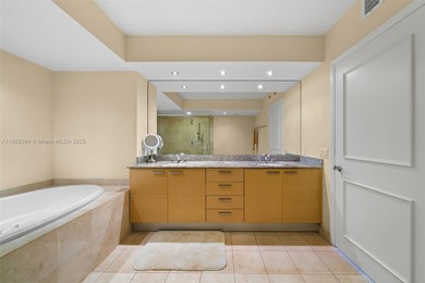 This luxurious beachfront unit features two bedrooms plus a den