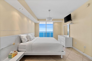This luxurious beachfront unit features two bedrooms plus a den