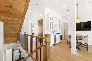 Anchored in the exclusive Palm Court enclave just south of 30A