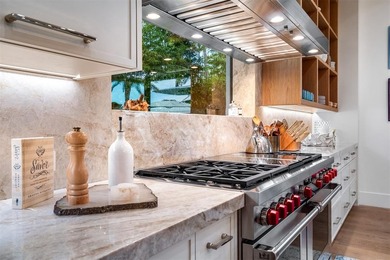 TIMELESS WATERFRONT MASTERPIECE IN EXCLUSIVE HARBOR BEACH! A