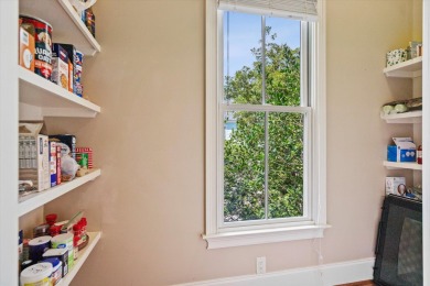 Nestled on a picturesque tree-lined street, this expansive home