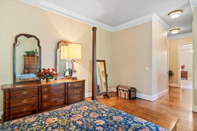 Nestled on a picturesque tree-lined street, this expansive home