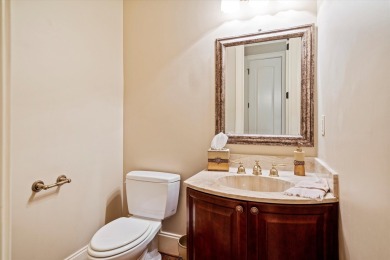 Nestled on a picturesque tree-lined street, this expansive home