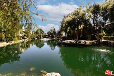 Come to see this recently refreshed townhome with the rare lake