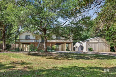 Welcome to this stunning waterfront retreat in Summerdale that