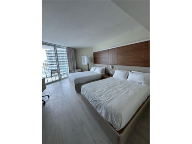 Welcome to Unit 1215 at The Q Club, a luxury condo-hotel