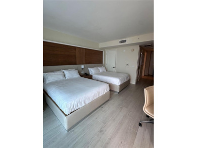 Welcome to Unit 1215 at The Q Club, a luxury condo-hotel