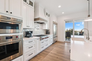 Completed in 2024, this stunning harborfront home offers the