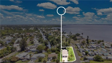 **SHORT SALE!** Light-filled corner home on the Caloosahatchee