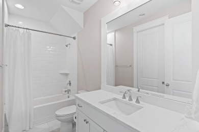 Welcome to refined coastal living in this exquisite end-unit