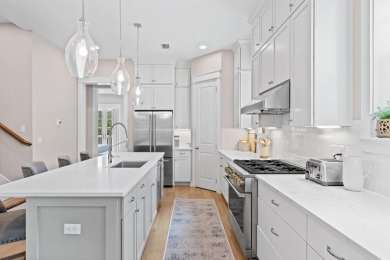 Welcome to refined coastal living in this exquisite end-unit