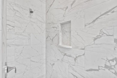 Welcome to refined coastal living in this exquisite end-unit