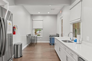 Welcome to refined coastal living in this exquisite end-unit