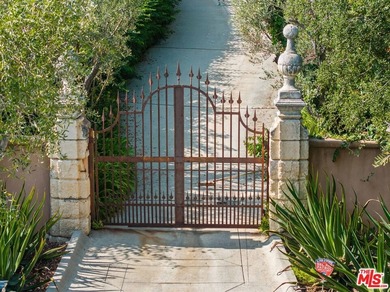 Welcome to this Majestic Gated Italian Villa nestled behind