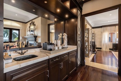 Experience unrivaled waterfront luxury at 210 Palm Avenue, a