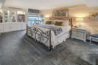 This SW CORNER unit has floor-to-ceiling windows and doors