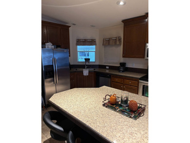 Welcome to your new home in a GATED 55+ community, offering the