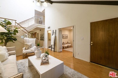 Come to see this recently refreshed townhome with the rare lake