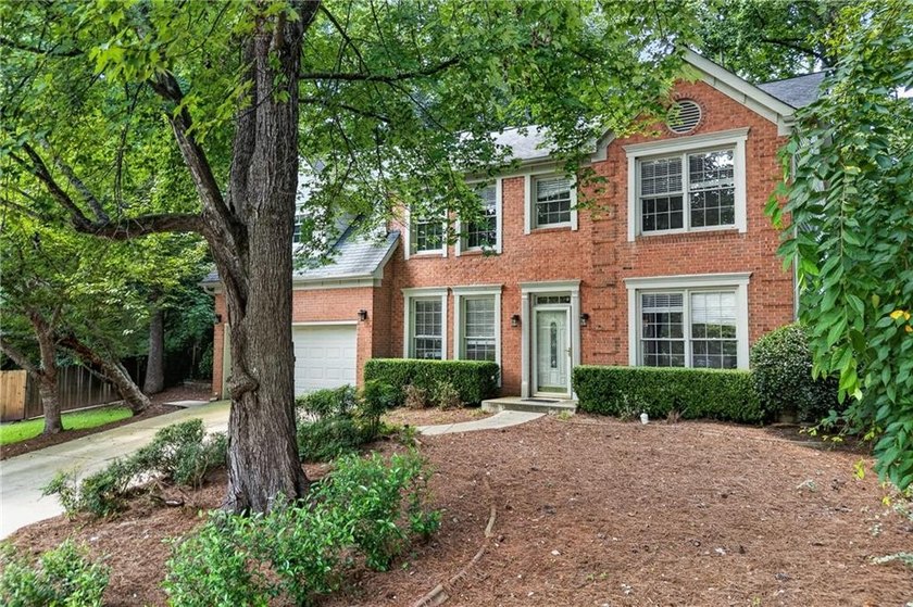 Welcome home to this beautifully maintained brick-front - photo 2