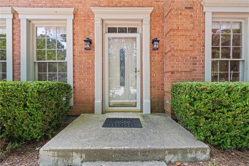 Welcome home to this beautifully maintained brick-front - photo 3