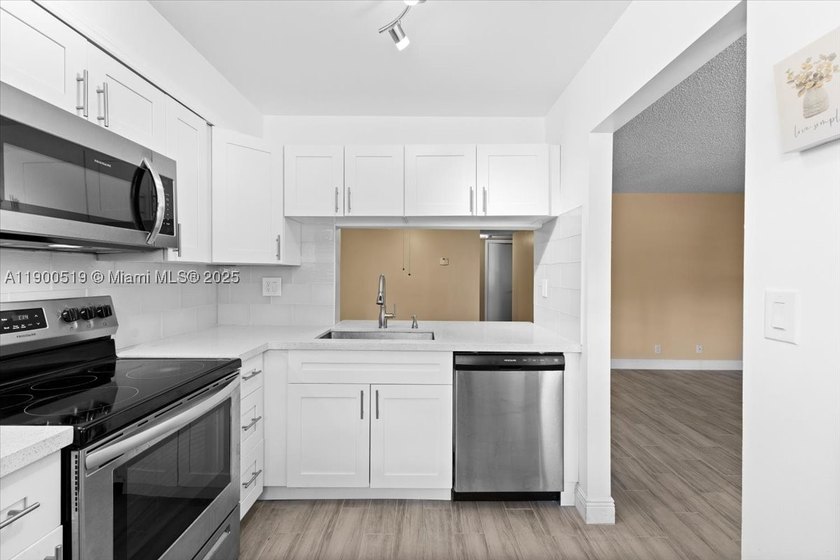Welcome to this beautifully upgraded corner unit condo in the - photo 3