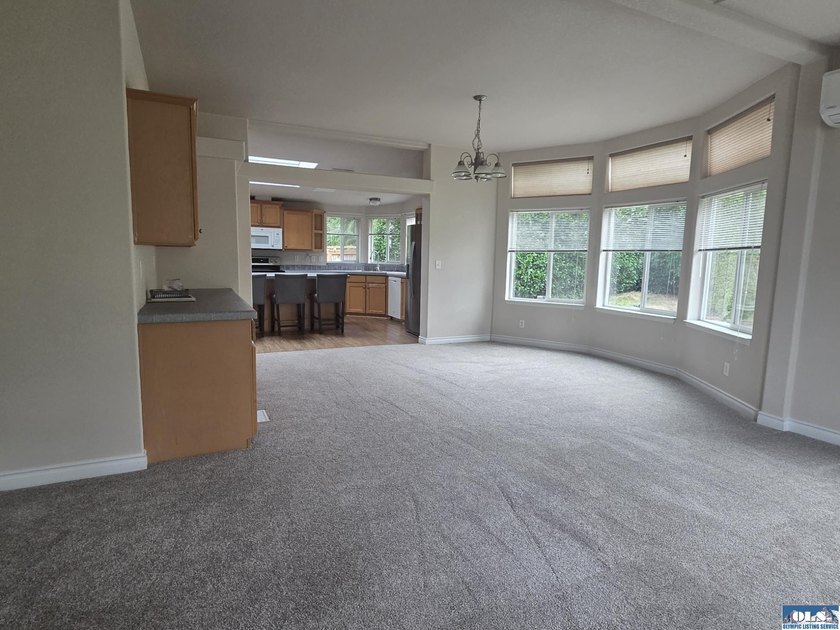 Space and natural light abound in this beautifully maintained - photo 5