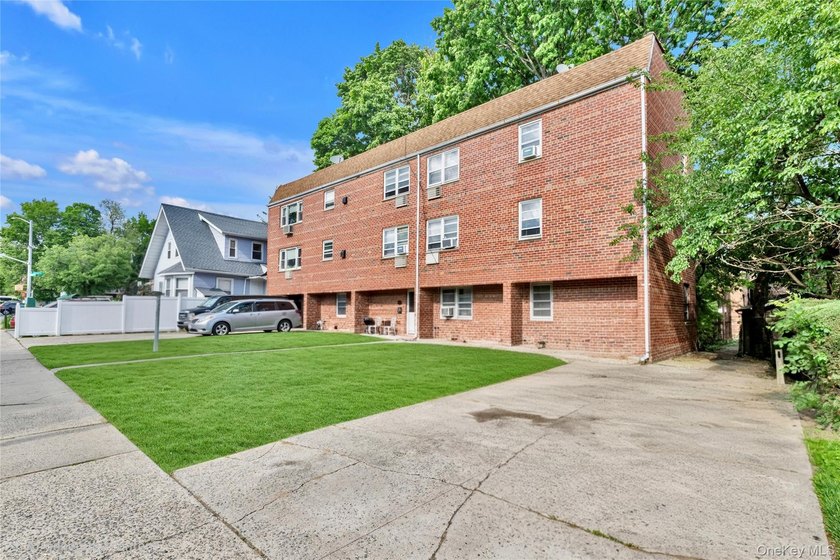 36-11 Utopia Parkway is a detached brick legal 2-family home - photo 2