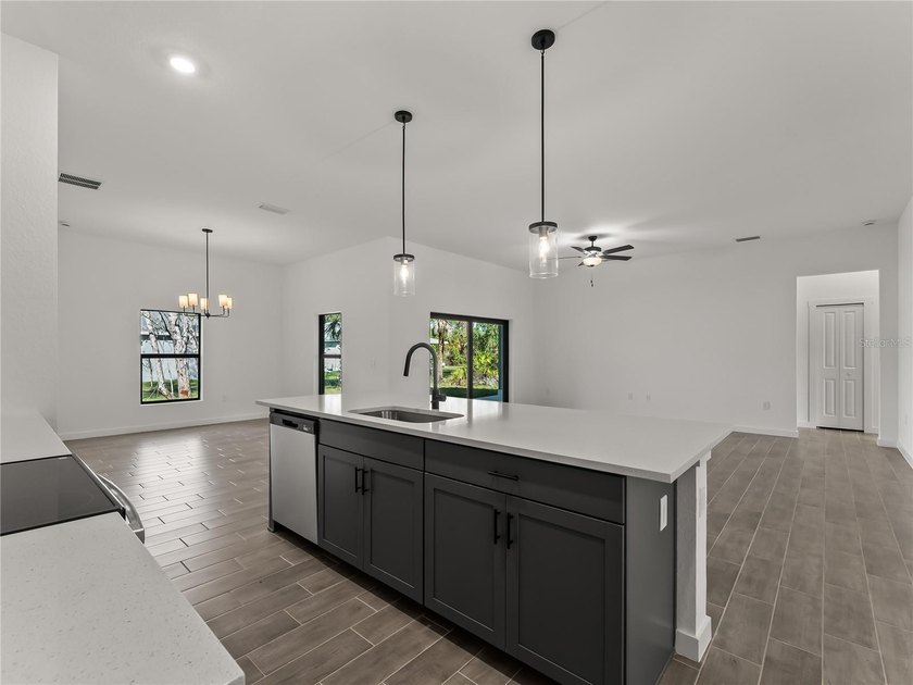 Virtually Staged. Tile throughout. Quartz countertops. Impact - photo 11