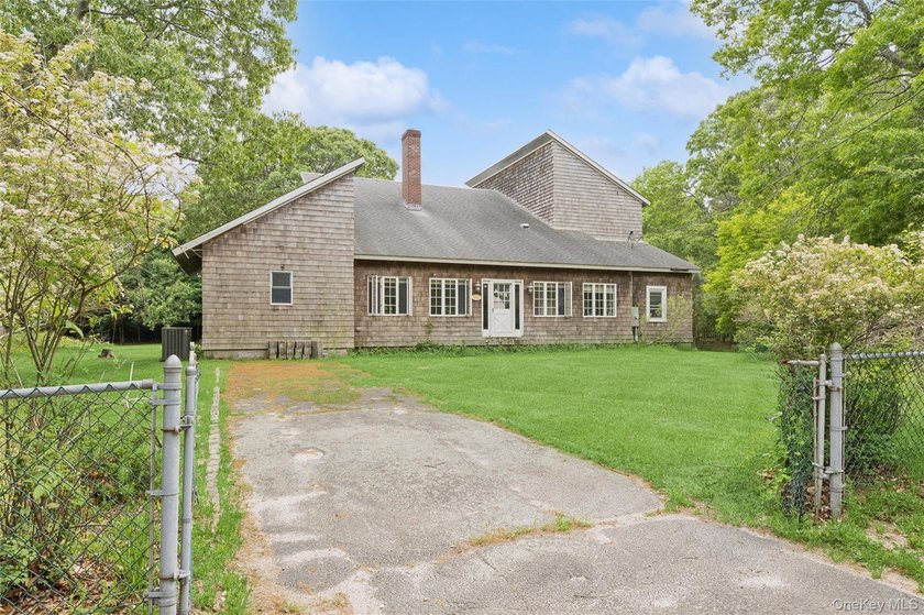 Set on a private 1.18-acre property in Hampton Bays, this - photo 3