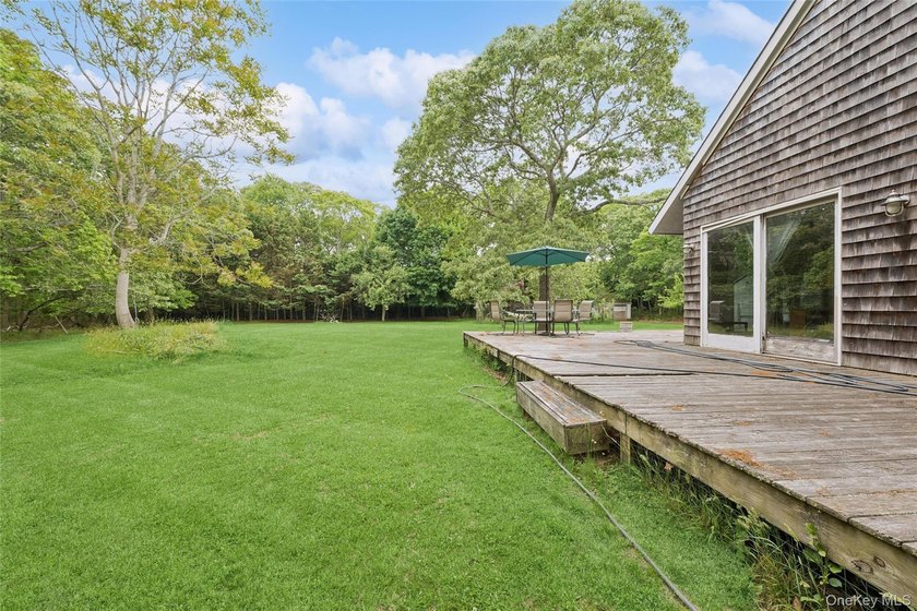 Set on a private 1.18-acre property in Hampton Bays, this - photo 4