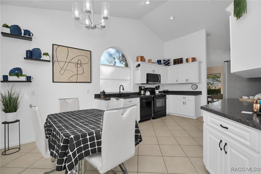 Enter to vaulted ceilings, beautiful bamboo floors in living and - photo 15